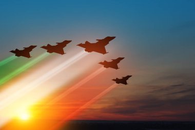 Aircraft silhouettes with flag color trails on background of sunset. Air Force Day. 28 March, Italian Air Force.