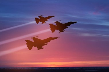 Air Force Day. Aircraft silhouettes on background of sunset. Combat flight of interceptors on a mission.