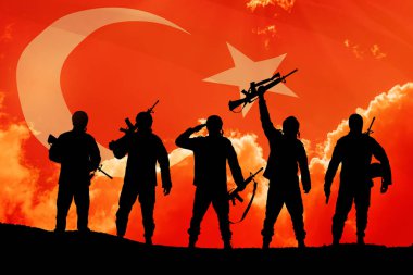 Silhouettes of soldiers on a background of Turkey flag and the sunset or the sunrise. Concept of crisis of war and conflicts between nations. Greeting card for Turkish Armed Forces Day, Victory Day.