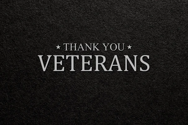 Text Thank You Veterans on black textured background. American holiday typography poster. Banner, flyer, sticker, greeting card, postcard.