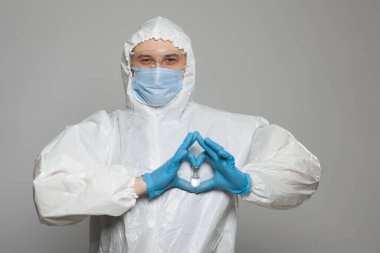 Closeup of vial to vaccinate in scientific virologist hand for immunization. Scientific virologist. Biologist in protective suit and blue gloves. Vaccination concept.
