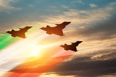 Aircraft silhouettes with flag color trails on background of sunset. Air Force Day. 28 March, Italian Air Force.