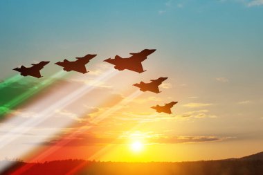 Aircraft silhouettes with flag color trails on background of sunset. Air Force Day. 28 March, Italian Air Force.