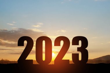 Siluet 2023, gün batımı gökyüzü dağda ve sayı 2023 gibi soyut bir arkaplan. Başlangıç stratejisi, kazanma, plan, hedef ve hedef kavramı.