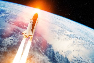 Spaceship lift off. Glowing space shuttle with smoke and blast takes off into the starry sky. Rocket starts into space. Concept. Elements of this image furnished by NASA.
