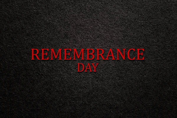 Text Remembrance Day on black textured background. Remembrance Day, Memorial Day, Anzac Day in New Zealand, Australia, Canada and Great Britain.