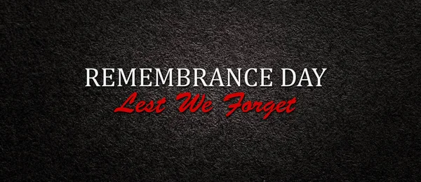 Text Remembrance Day Lest We Forget on black textured background. Remembrance Day, Memorial Day, Anzac Day. Banner.