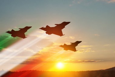 Aircraft silhouettes with flag color trails on background of sunset. Air Force Day. 28 March, Italian Air Force.