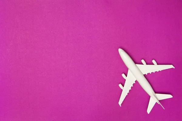 飛行機モデル 紫色の背景に白い飛行機 旅行休暇のコンセプト 夏の背景 フラットレイアウト トップビュー コピースペース — ストック写真