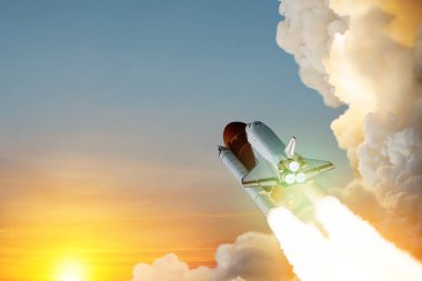 Spaceship lift off. Space shuttle with smoke and blast takes off into space on a background of sunset. Successful start of a space mission. Travel to Mars. Elements of this image furnished by NASA.