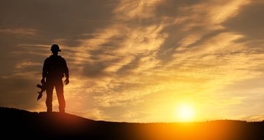 Silhouette of soldier standing against the backdrop of a sunset. Greeting card for Veterans Day, Memorial Day, Independence Day. USA celebration. Concept - patriotism, protection, remember honor.