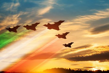 Aircraft silhouettes with flag color trails on background of sunset. Air Force Day. 28 March, Italian Air Force.