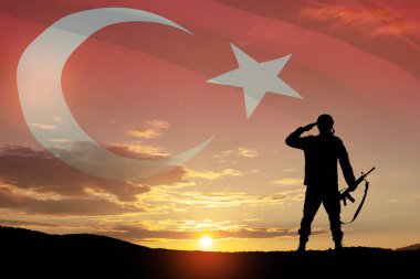 Silhouette of soldier on a background of Turkey flag and the sunset or the sunrise. Concept of crisis of war and conflicts between nations. Greeting card for Turkish Armed Forces Day, Victory Day.