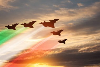 Aircraft silhouettes with flag color trails on background of sunset. Air Force Day. 28 March, Italian Air Force.