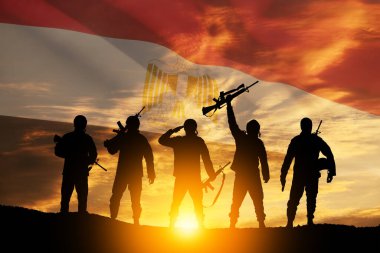 Double exposure of silhouettes of a soliders and the sunset or the sunrise against flag of Egypt. Greeting card for Independence day, Memorial Day, Armed forces day, Sinai Liberation Day.