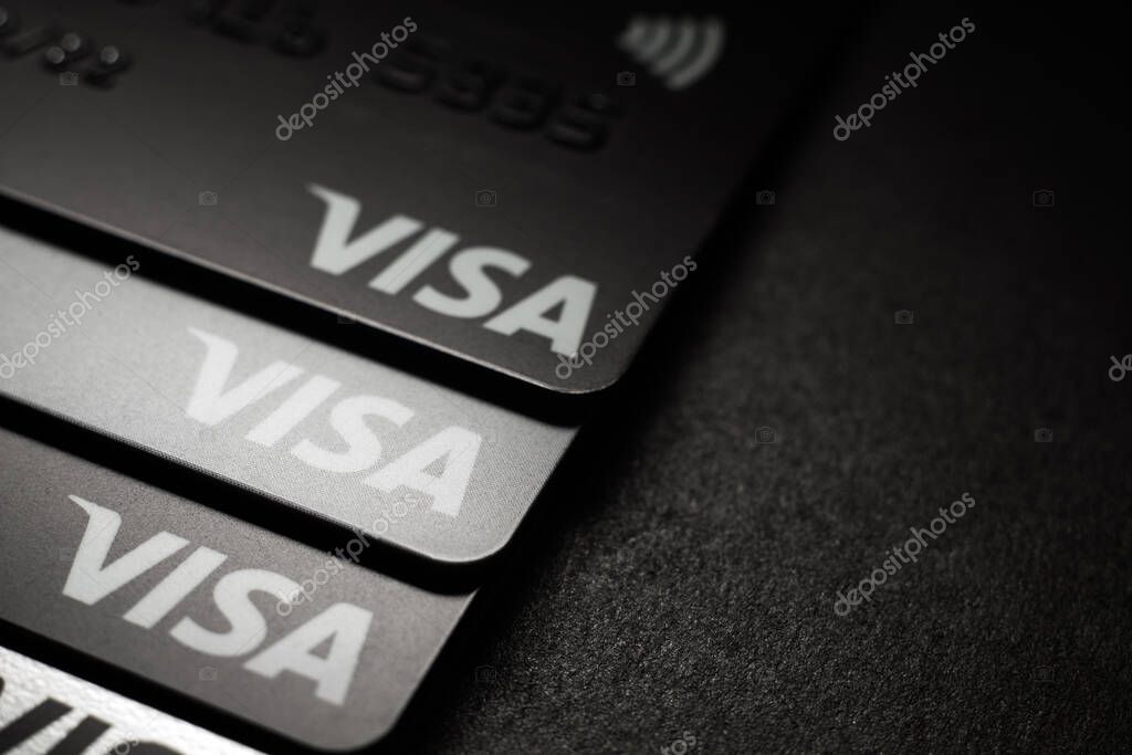 Close-up of Visa credit cards placed on a dark background. Macro photo. Moscow, Russia - March 14, 2022.
