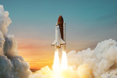 Spaceship lift off. Space shuttle with smoke and blast takes off into space on a background of sunset. Successful start of a space mission. Travel to Mars. Elements of this image furnished by NASA.