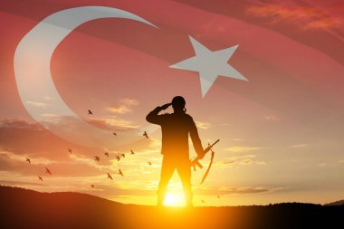 Silhouette of soldier on a background of Turkey flag and the sunset or the sunrise. Concept of crisis of war and conflicts between nations. Greeting card for Turkish Armed Forces Day, Victory Day.
