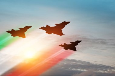 Aircraft silhouettes with flag color trails on background of sunset. Air Force Day. 28 March, Italian Air Force.