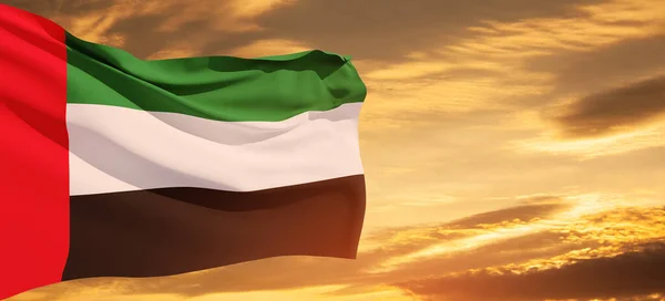 stock image Flag of United Arab Emirates on background of sunset sky. UAE celebration. National day, Flag day, Commemoration day, Martyrs day. Banner with place for text.