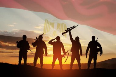 Double exposure of silhouettes of a soliders and the sunset or the sunrise against flag of Egypt. Greeting card for Independence day, Memorial Day, Armed forces day, Sinai Liberation Day.