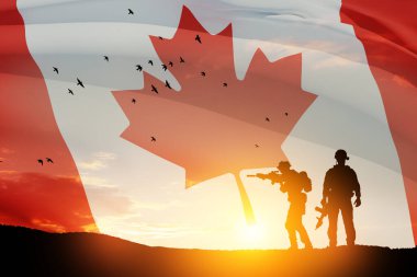 Canada army soldiers on a background of sunset or sunrise and Canada flag. Greeting card for Poppy Day, Remembrance Day. Canada celebration. Concept - patriotism, honor.