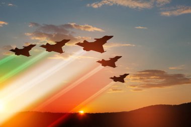 Aircraft silhouettes with flag color trails on background of sunset. Air Force Day. 28 March, Italian Air Force.