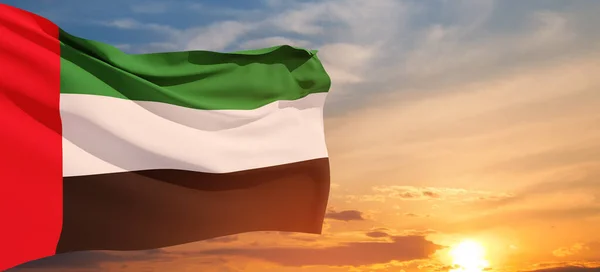 stock image Flag of United Arab Emirates on background of sunset sky. UAE celebration. National day, Flag day, Commemoration day, Martyrs day. Banner with place for text.