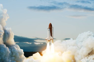 Spaceship lift off. Space shuttle with smoke and blast takes off into space on a background of blue sky. Successful start of a space mission. Elements of this image furnished by NASA.