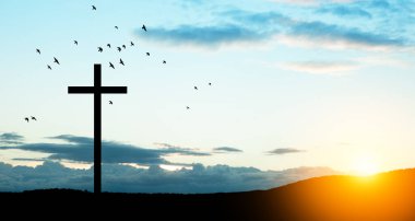 Christian cross on hill outdoors at sunrise. Resurrection of Jesus. Concept photo.