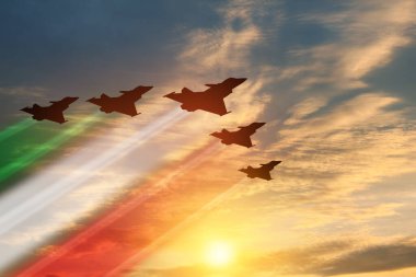 Aircraft silhouettes with flag color trails on background of sunset. Air Force Day. 28 March, Italian Air Force.