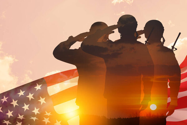 Silhouettes of soldiers with print of sunset saluting on a background of USA flag and sky. Greeting card for Veterans Day, Memorial Day, Independence Day. America celebration. Closeup. 3D-rendering.