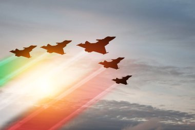 Aircraft silhouettes with flag color trails on background of sunset. Air Force Day. 28 March, Italian Air Force.