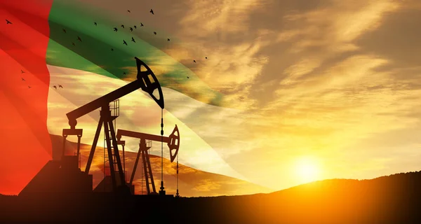 The change in oil prices caused by the war. Oil prices are rising because of the global crisis. Oil drilling derricks at desert oilfield with UAE flag. Crude oil production from the ground.