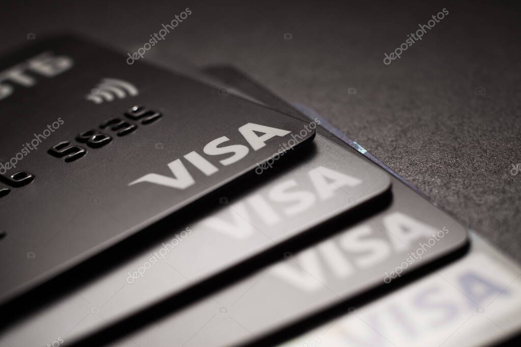 Close-up of Visa credit cards placed on a dark background. Macro photo. Moscow, Russia - March 14, 2022.