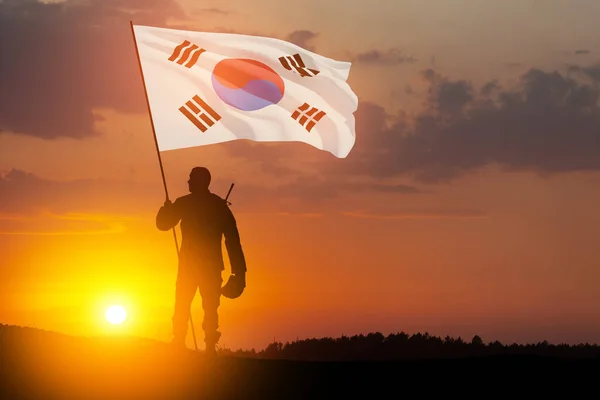 stock image Silhouette of soldier with South Korea flag against the sunrise or sunset. Concept - armed forces of Korea. Greeting card for Memorial Day, Liberation Day. Korean celebration. 3D-render.