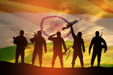 Silhouettes of soldiers on a background of India flag and the sunset or the sunrise. Greeting card for Independence day, Republic Day. India celebration.
