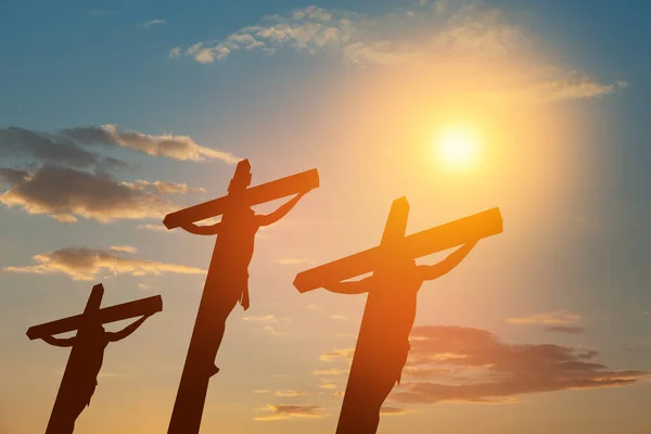十字架につけられたイエス キリストのシルエットは 日没の空を背景に他の人々と共に — ストック写真