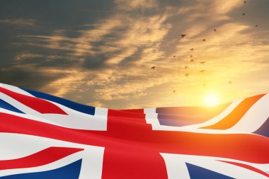 National flags of United Kingdom with flying birds on sunset sky background. Background with place for your text. 3d rendering.