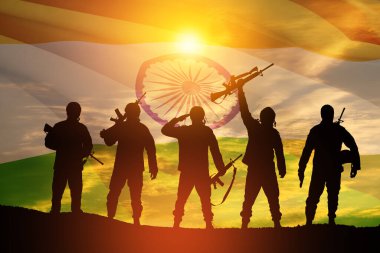 Silhouettes of soldiers on a background of India flag and the sunset or the sunrise. Greeting card for Independence day, Republic Day. India celebration.