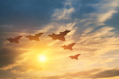 Hava Kuvvetleri Günü. Gün batımının veya güneşin doğuşunun arka planında uçak siluetleri.