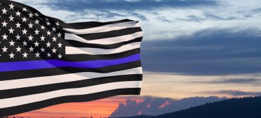 American flag with police support symbol Thin blue line on sunset sky. American police in society as the force which holds back chaos, allowing order and civilization to thrive. Banner.