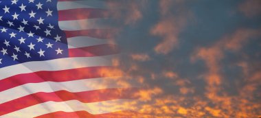 United States of America flag on sky at sunset or sunrise background. Independence day, Memorial day, Veterans day. Banner.