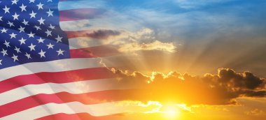 United States of America flag on sky at sunset or sunrise background. Independence day, Memorial day, Veterans day. Banner.