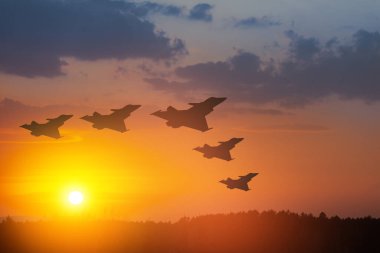 Air Force Day. Aircraft silhouettes on background of sunset or sunrise. clipart