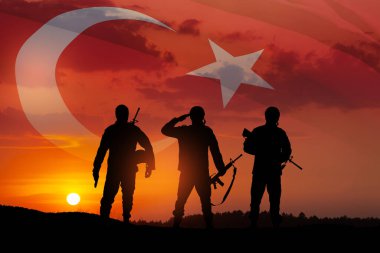 Silhouettes of soldiers on a background of Turkey flag and the sunset or the sunrise. Concept of crisis of war and conflicts between nations. Greeting card for Turkish Armed Forces Day, Victory Day.