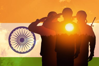 Double exposure of Silhouettes of soliders and the sunset or the sunrise against India flag. Greeting card for Independence day, Republic Day. India celebration.