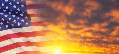 United States of America flag on sky at sunset or sunrise background. Independence day, Memorial day, Veterans day. Banner.