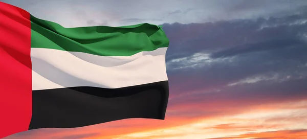 stock image Flag of United Arab Emirates on background of sunset sky. UAE celebration. National day, Flag day, Commemoration day, Martyrs day. Banner with place for text.