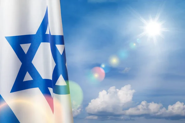 stock image Israel flag with a star of David over cloudy sky background. Patriotic concept about Israel with national state symbols. Banner with place for text.